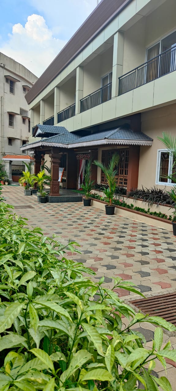 Front view of Hotel Parijatha Inn Dharmasthala — main entrance with traditional architecture