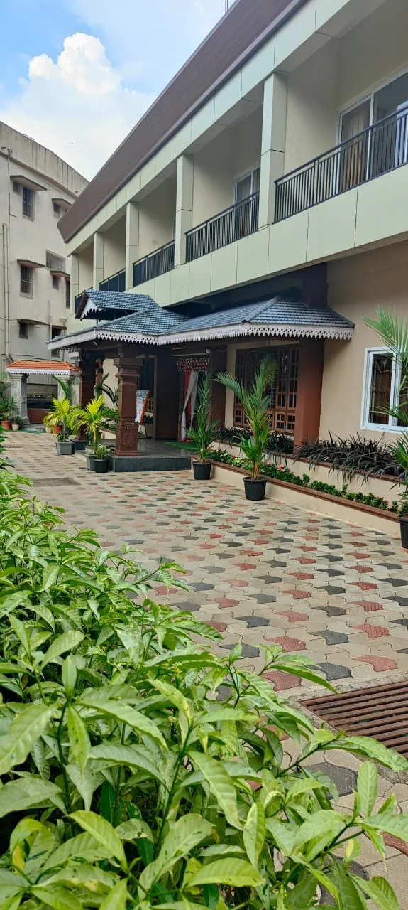 Front view of Hotel Parijatha Inn Dharmasthala - multi-story building with traditional architecture